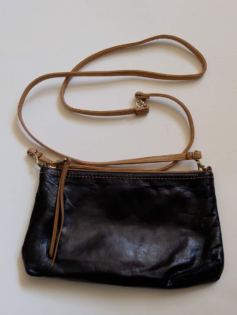Sleek Black Leather Crossbody with Tan Strap
